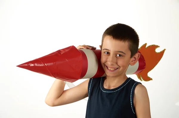 A boy with a toy red and white rocket on his shoulder — Stock Photo, Image