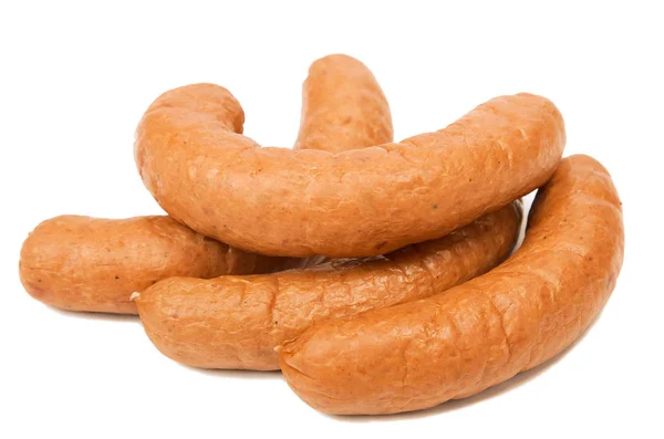 Sausages for the picnic. Fast food. Grilled sausages on white background, street food. Juicy sausages. Harmful food on a light background. Fatty food. — Stock Photo, Image
