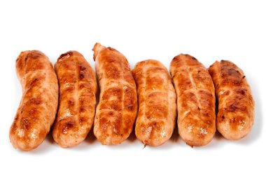 Meat sausages with glitter on a light background. Fried sausage. The concept of traditional cuisine.