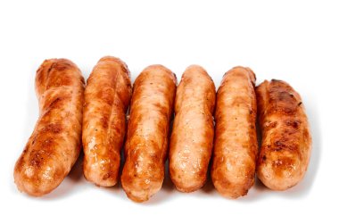 Meat sausages with glitter on a light background. Fried sausage. The concept of traditional cuisine.