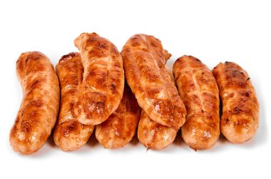 Meat sausages with glitter on a light background. Fried sausage. The concept of traditional cuisine.