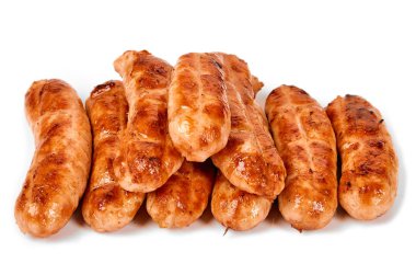 Meat sausages with glitter on a light background. Fried sausage. The concept of traditional cuisine.