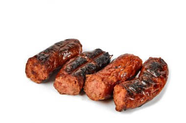 Meat sausages with glitter on a light background. Fried sausage. The concept of traditional cuisine.