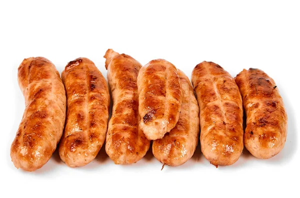 Meat sausages with glitter on a light background. Fried sausage. The concept of traditional cuisine. — Stock Photo, Image
