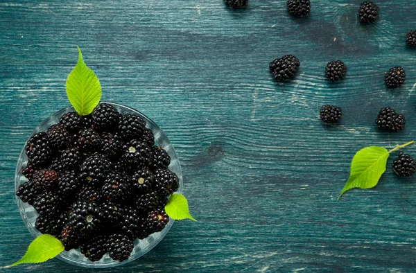 Fresh blackberry. Juicy blackberry in a bowl on a wooden table. View from above. Copy space. Harvest concept