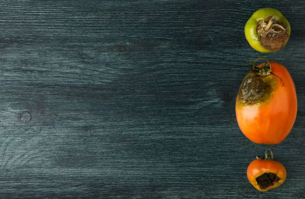 VEGETABLES ON BACKGROUND. SICK VEGETABLES ON A WOODEN SURFACE. COPY SPACE