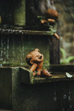 Tayland - 2019. Phuket Botanik Bahçesi. Heykel Kız suyla oynuyor. Arkaplan sanatsal fikir için bulanık.