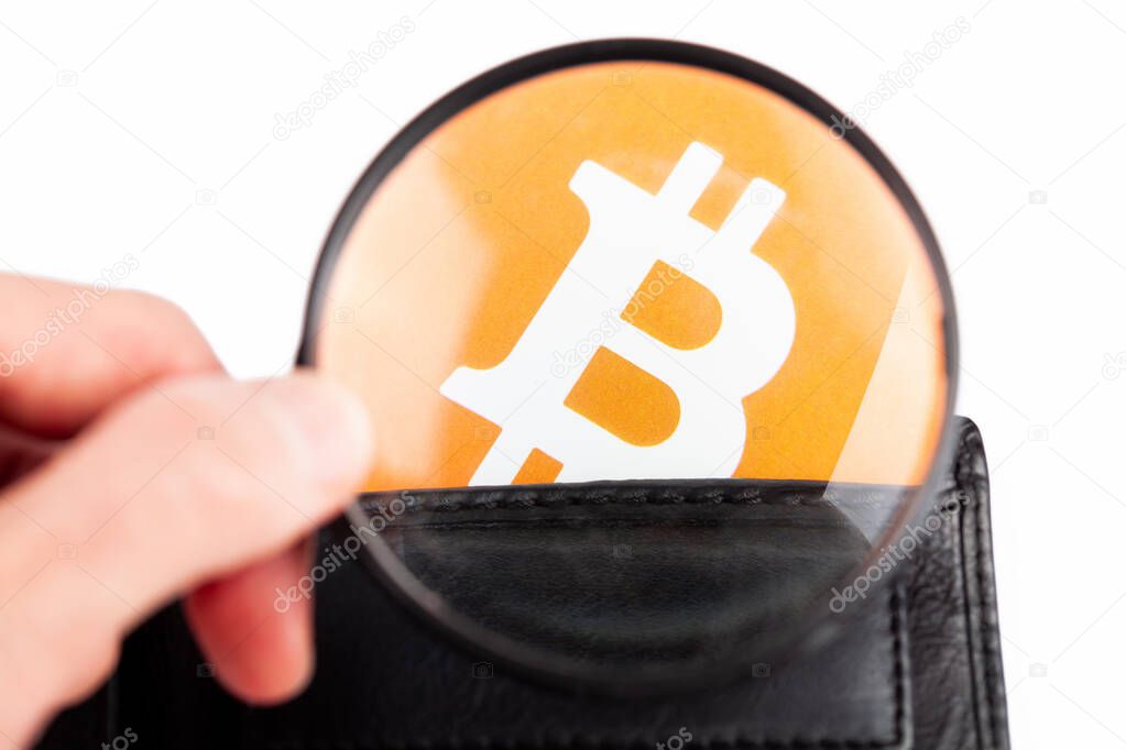 Closer look at bitcoin logo, symbol in a wallet, man examining BTC cryptocurrency, magnifying glass in hand. Crypto currency wallets, storing digital currencies solutions research abstract concept