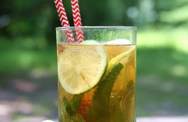 Kombucha Tea Fermented Super Food In Glass With Straw With Mint And Lemon, Lime On Wooden Table, Close Up.