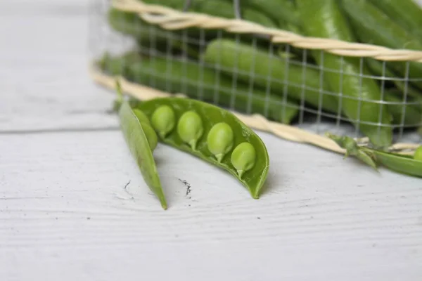 Taze yeşil bezelye kabuğu beyaz arkaplanda izole edilmiş..
