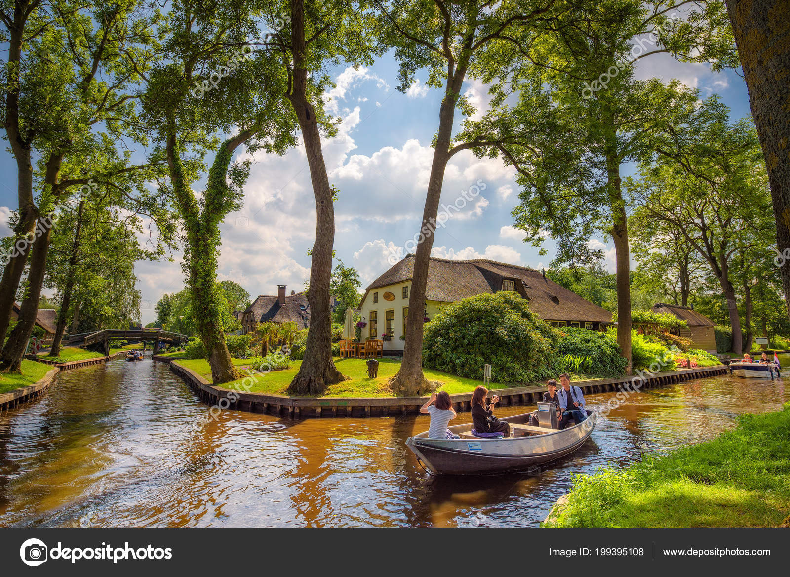 Tourists on a sightseeing boat in the village of Giethoorn, Netherlands