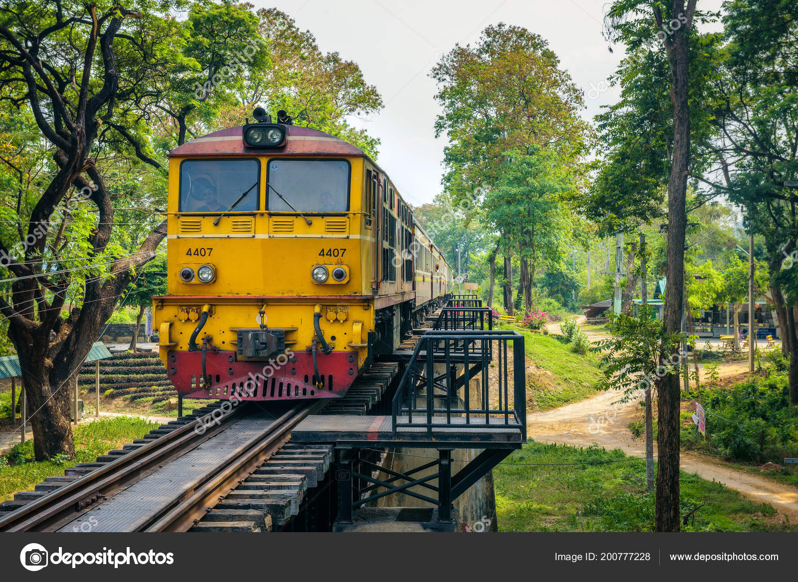 Thai train on the historical bridge over the river Kwai Stock