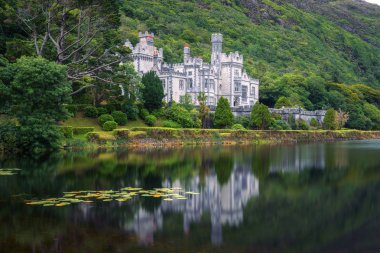 Kylemore Abbey in Ireland with reflections in the Pollacapall Lough clipart