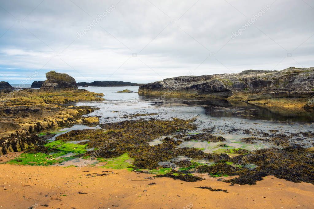 Dramatic landscape of the Ballintoy Harbor shoreline in Northern Ireland
