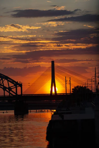Suspension bridge and the railway bridge at sunset. Riga, Latvia