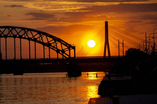 Suspension bridge and the railway bridge at sunset. Riga, Latvia