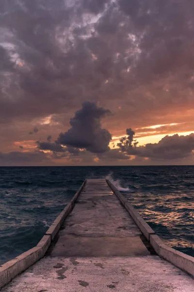 incredible sunsets on the black sea. Clouds over sea. A splash of water. Waves. Sunset at sea. The road through horizon. pier in sea.