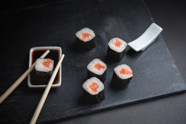 Sushi on a black background. Perfect for creating a sushi restaurant menu. Japanese cuisine, Eastern culture.