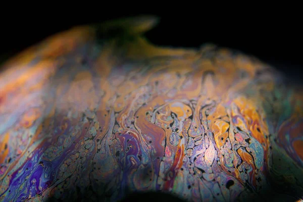 Siyah arkaplanlı renkli sabun köpüğü.