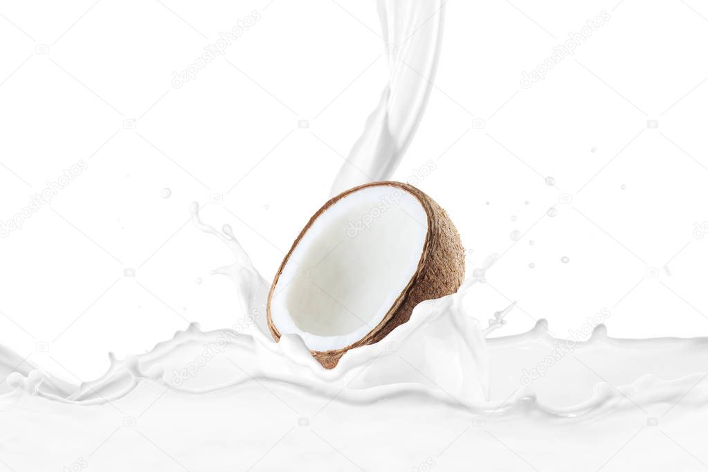 milk pouring on fresh halved coconut with splashes 
