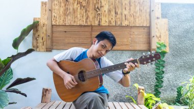 Parkta gitar çalan bir adam.