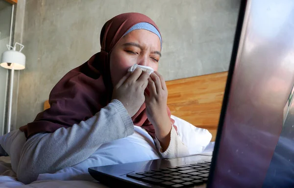 Asian girl crying watching a movie on a laptop