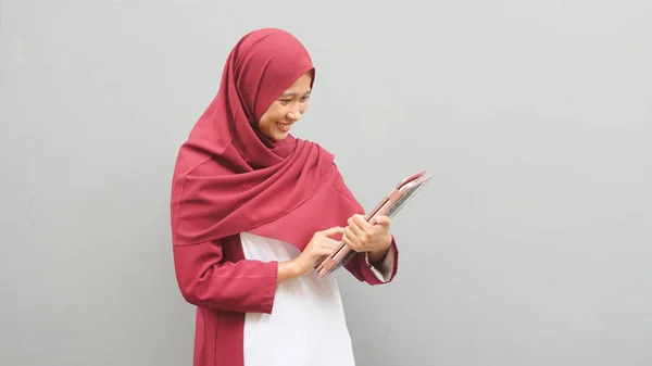 Asian muslim woman with notebook. Teacher profession