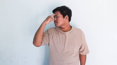 Bir şey düşünüp, fikir üreten şişman Asyalı adam.