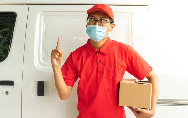 Asian young man delivery in red uniform with packages and thinking expression