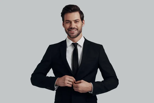Always in style. Handsome young man in full suit adjusting jacke — Stock Photo, Image