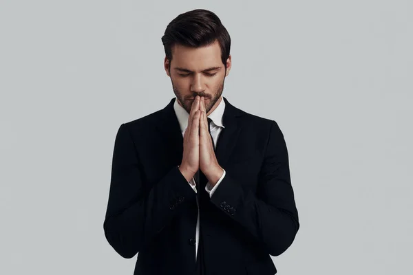 Trying to find harmony. Handsome young man in full suit keeping — Stock Photo, Image