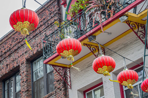 Red and gold Chinese lanterns hang in the Chinatown district of San Francisco, California, USA.