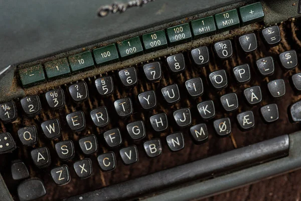 Old and dusty mechanical typewriter made in grey metal.
