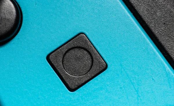 青いハンドコントローラーの黒い四角形のボタン — ストック写真