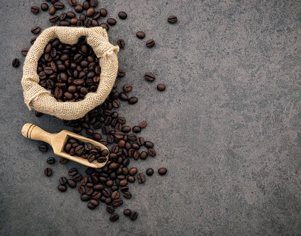 Dark roasted coffee beans on stone background. Top view with cop — Stock Photo, Image