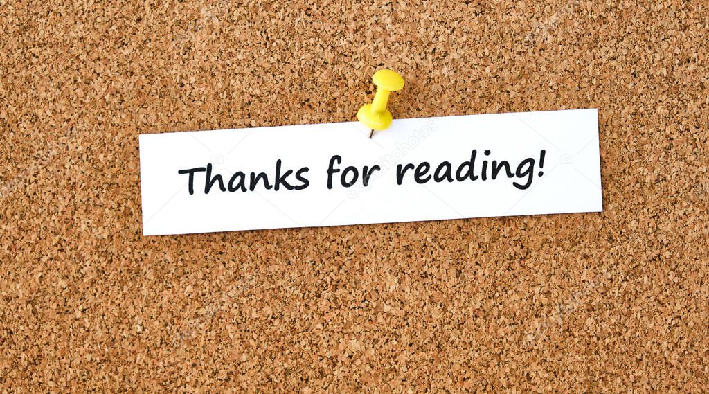 Thanks for reading. Text written on a piece of paper or note, cork board background.