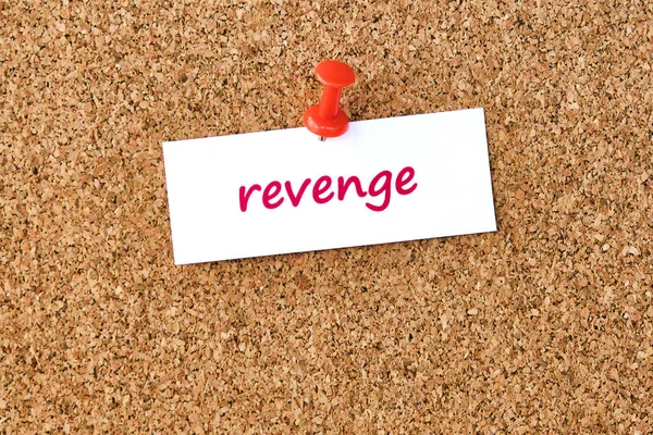 Revenge. Word written on a piece of paper or note, cork board background.