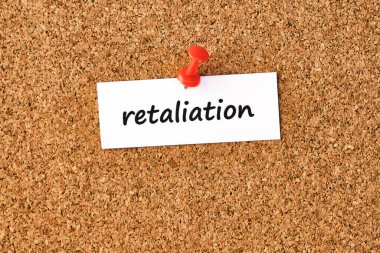 Retaliation. Word written on a piece of paper or note, cork board background. clipart
