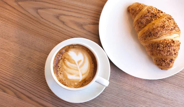 Cappuccino and croissant.