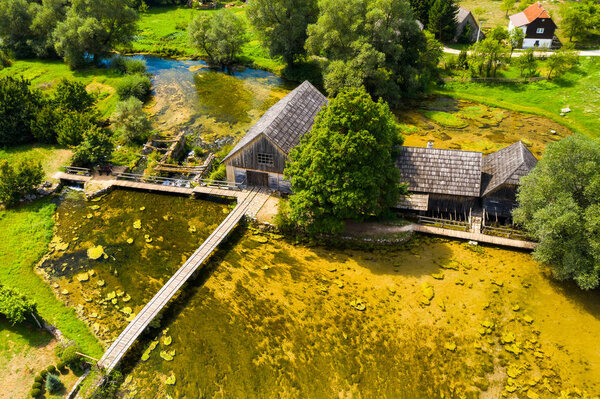 Majerovo vrilo river source of Gacka aerial drone view, Lika region countryside of Croatia, old wooden mills and cottages