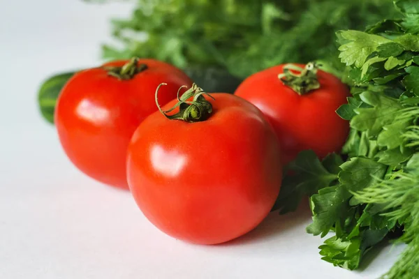 Isolated Vegetables on White Background: Tomatoes, Cucumber and Greens