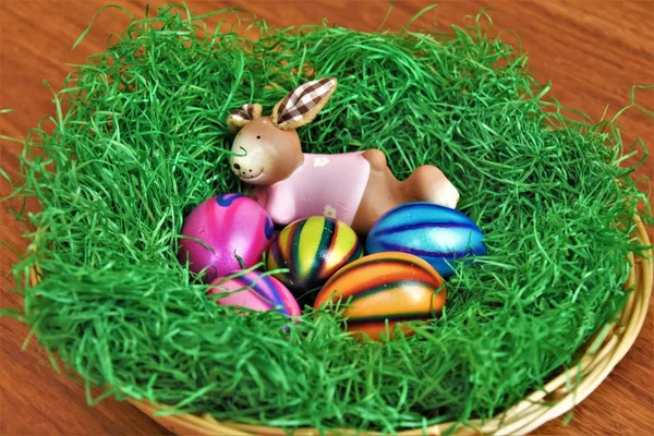 Decorative Clay Hare Lying Grass Painted Eggs — Stock Photo, Image