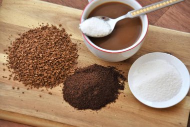 kahve, toz süt, zemin kahve ve granül ile bir kaşık fincan