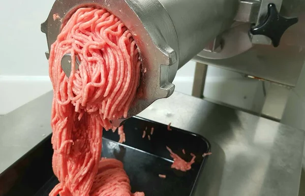 meat twisted in a large meat grinder