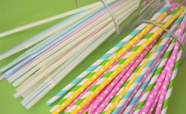  multicolored disposable padlchki, plastic and paper on a green background