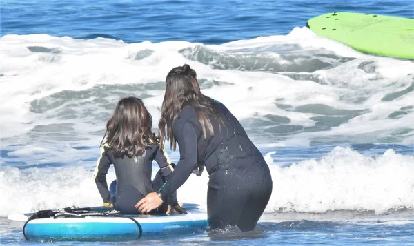 在海上冲浪板上的妇女和女孩 — 图库照片
