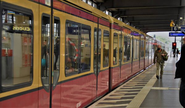Berlin Germany June 2020, masked passengers and wagons of a city train at the train station Zoological Garden