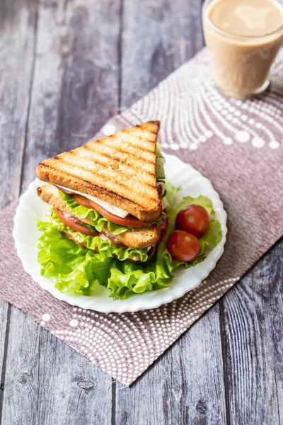 Sandwich with cheese, tomato, cucumber, sausage and lettuce on a wooden background. Vertical orientation — Stock Photo, Image