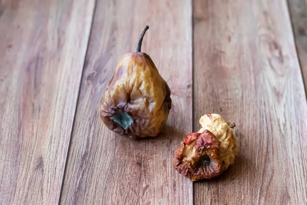 Fruta de pêra estragada podre. Núcleo da Apple. Pêras podres em um fundo escuro. Produtos danificados, mofo. Copie espaço para o seu texto. Natureza morta com fruto . — Fotografia de Stock