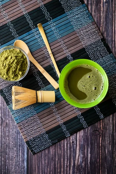 Matcha de té verde en un tazón sobre una superficie de madera. Vista superior, contiene antioxidantes, desintoxicación. Orientación vertical — Foto de Stock